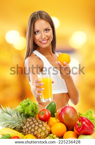 Shopping concept. Beautiful young woman with fruits and vegetables and glass of juice on shop background