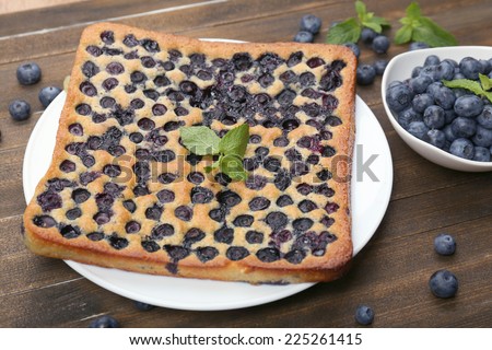 Tasty blueberry pie on table