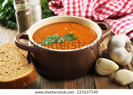 Delicious lentil cream-soup on table close-up
