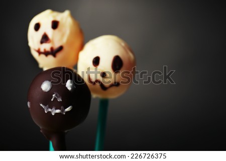 Funny Halloween cake pops on dark background