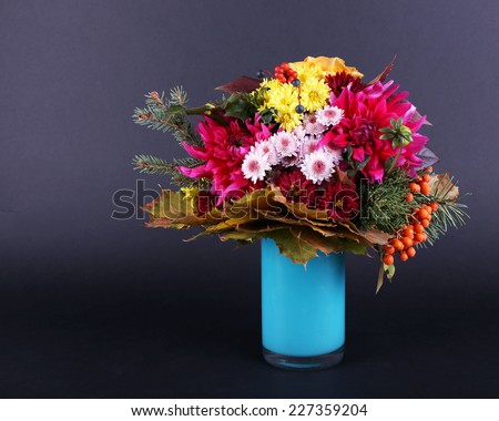 Flower bouquet in blue vase on dark grey background