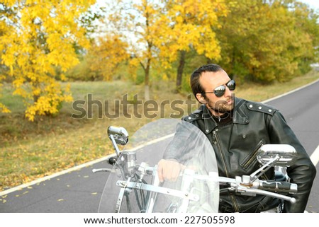 Biker man sits on bike