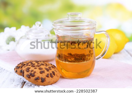 Cup of tea on table on bright background