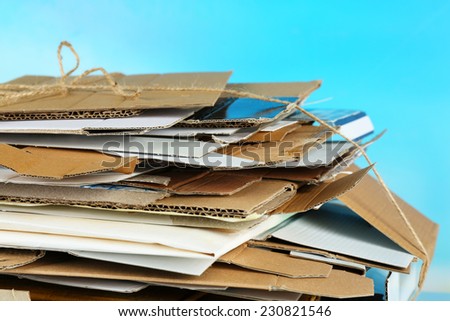 Big stack of papers on blue background, close-up