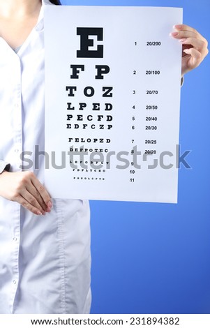 Health care, medicine and vision concept - woman with eye chart