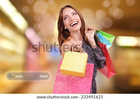 Shopping concept. Beautiful young woman with shopping bags on bright background