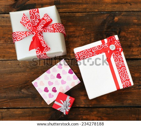 Gift boxes with card on wooden background
