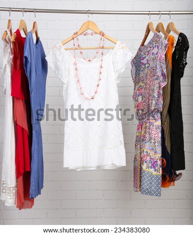Female dresses on hangers in room