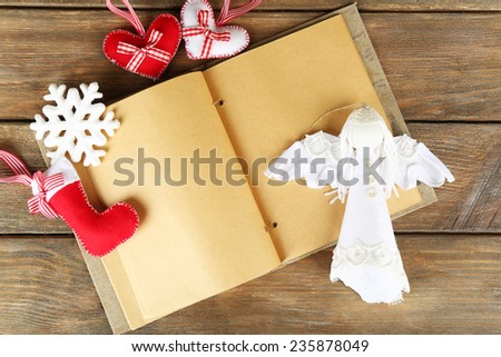 Handmade Christmas decorations  and old notebook on wooden background
