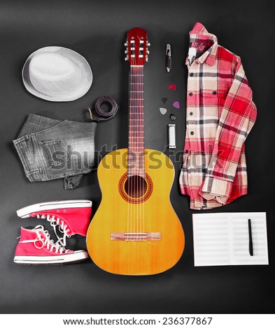Musical equipment, clothes and footwear on dark background