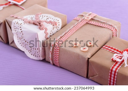 Group of handmade present boxes on purple background
