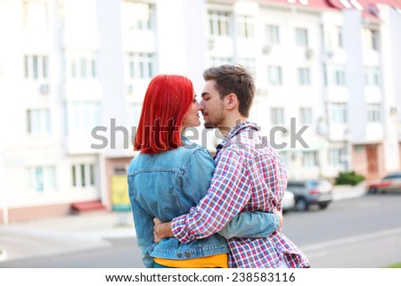 Loving couple near apartment house
