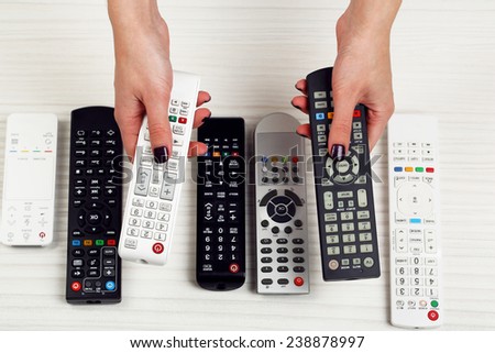 Many remote control devices in hands