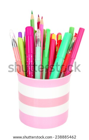 Colorful pens,pencils and markers in striped plastic cup isolated on white background