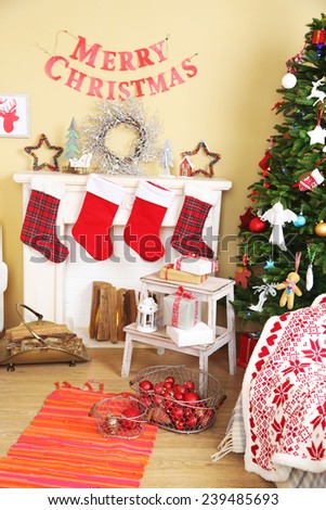 Beautiful Christmas interior with  decorative fireplace and fir tree