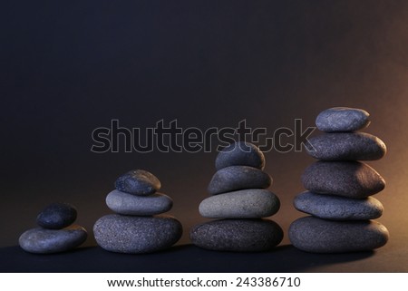Pyramid of spa stones on dark background