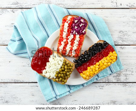 Sandwiches with  different flags on table close-up