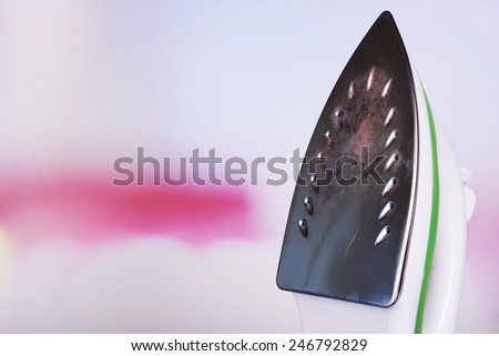 Flat iron with burnt mark on bright background
