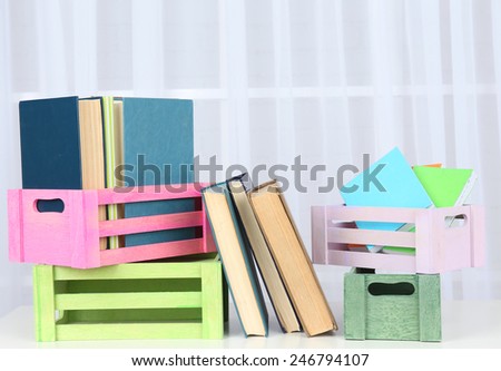 Many books in crates on light background