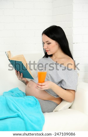 Young pregnant woman relaxing on sofa, close-up