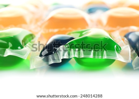 Gel capsules with laundry detergent close up