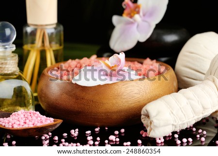 Beautiful spa composition with flowers on dark background