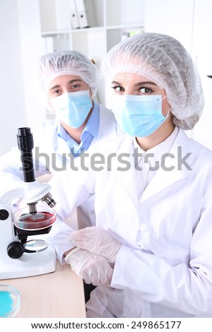 Portrait of male and female scientists in laboratory