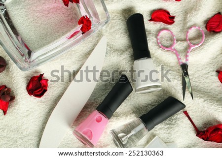 French manicure set with strengthener,white tip polish, dividers and top coat shine applicator for nails on towel background