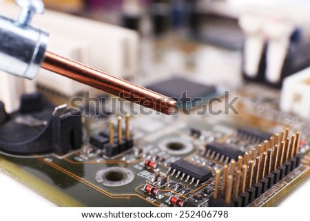 Motherboard repairing on white background