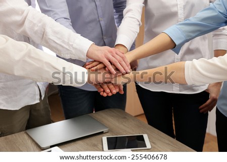 United hands of business team on workspace background
