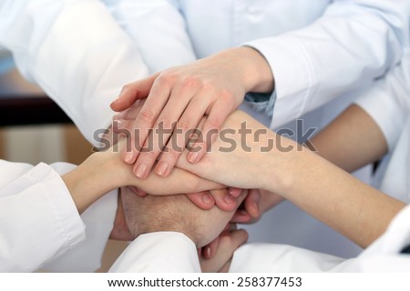 United hands of medical team close up