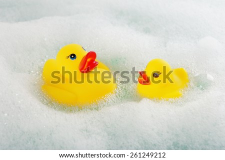 Rubber ducks in foam close-up