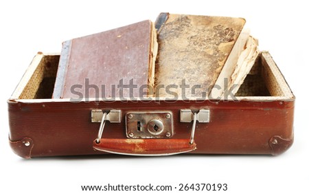 Old wooden suitcase with old books isolated on white