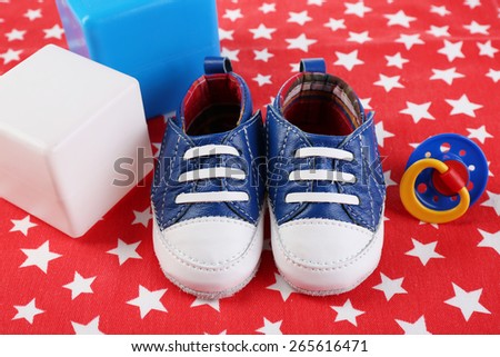 Baby shoes on red background