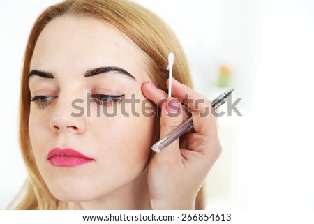Permanent make-up (tattoo) concept. On light background
