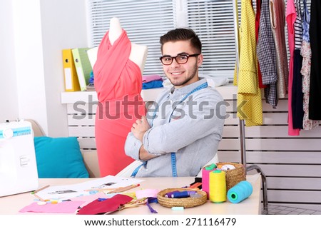Young man fashion designer in atelier