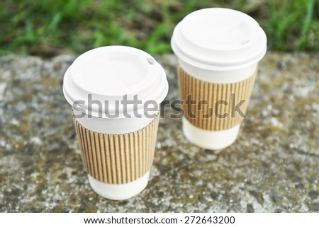 Paper cups on gray stone, outdoors
