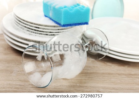 Dishes in foam with wisp on table close up