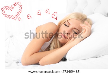 Beautiful young woman dreaming about love while sleeping