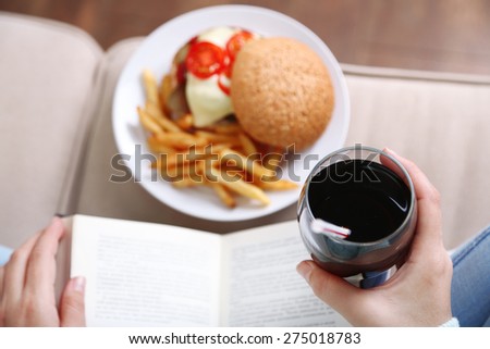 Woman with unhealthy fast food, close-up