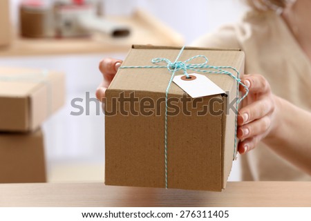 Woman gives parcel in post office