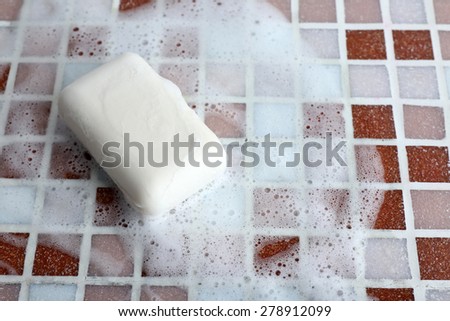 Soap with bubble on mosaic tiles background