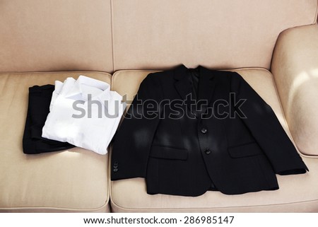 School clothes for boy on sofa