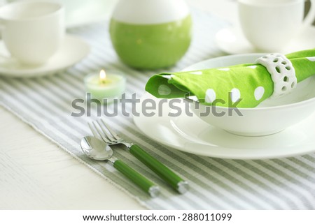 Beautiful holiday table setting in white and green color