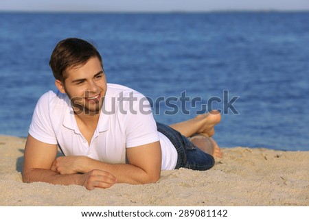 Pretty guy lying on beach