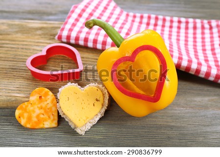 Salad pepper with cut in shape of heart and cheese on table close up