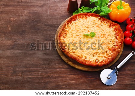 Cheese pizza with vegetables on table close up