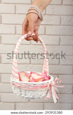 Girl holding  basket of flowers. Wedding concept