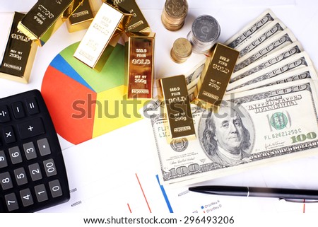 Gold bullion with money on table close up