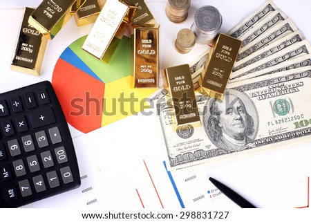 Gold bullion with money on table close up